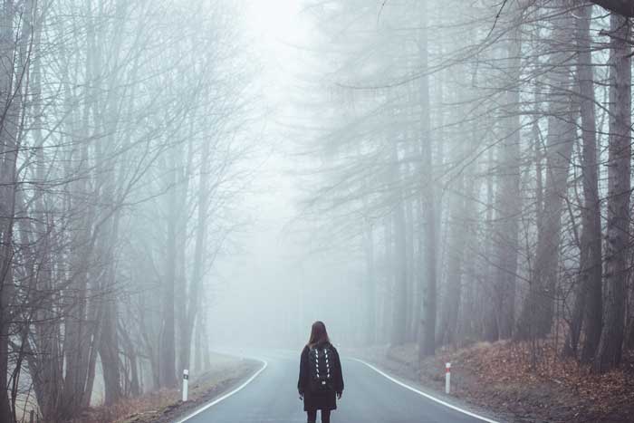 woman walking on a straight clear path